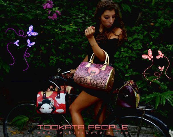Tookata campaign archive: model with illustrated bags beside a bicycle and colourful butterflies